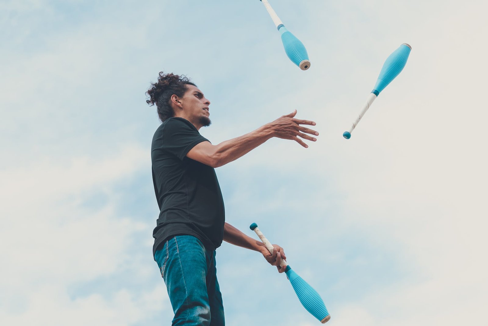 man in black t shirt and blue denim jeans jumping